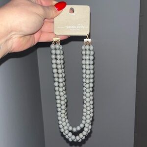 Gray triple strand beaded necklace